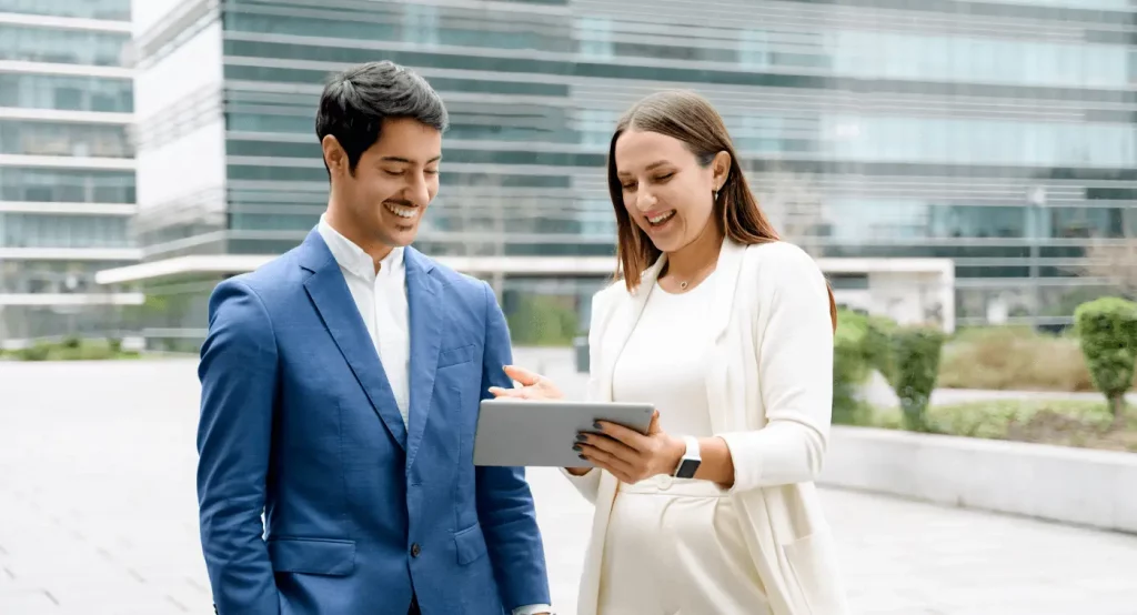 Two leaders using tablet to leverage the feedback by discussing the insights.